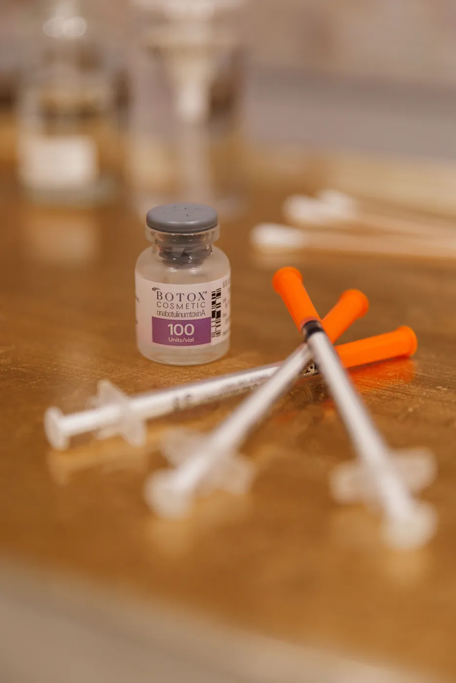 Botox Cosmetic vial beside syringes on a gold treatment tray