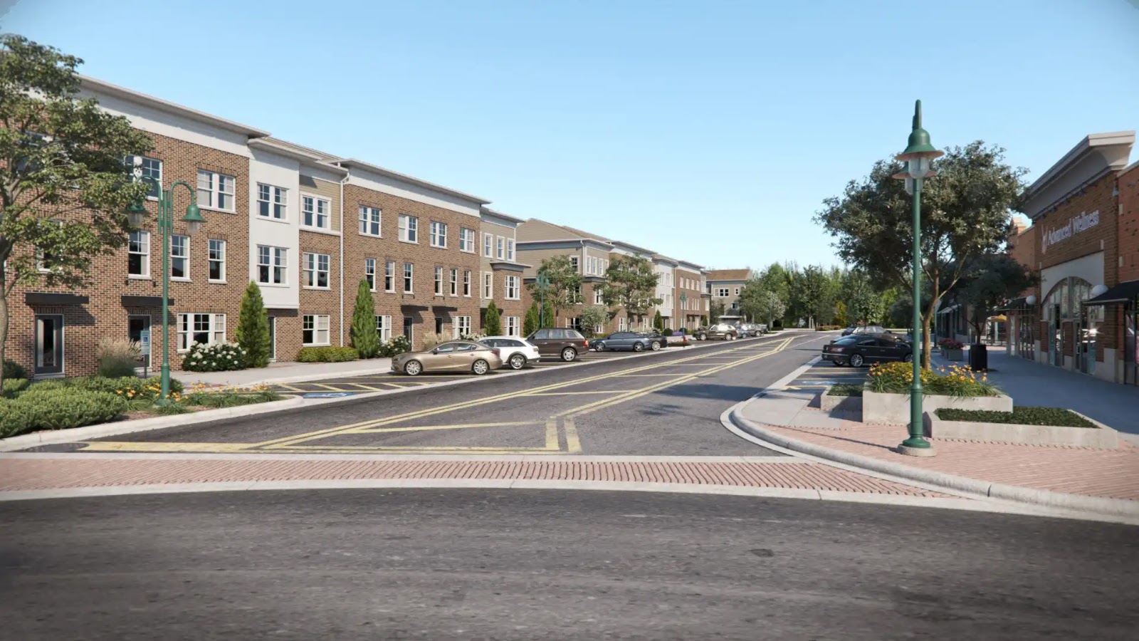 Street view of a multifamily residential development with brick buildings.