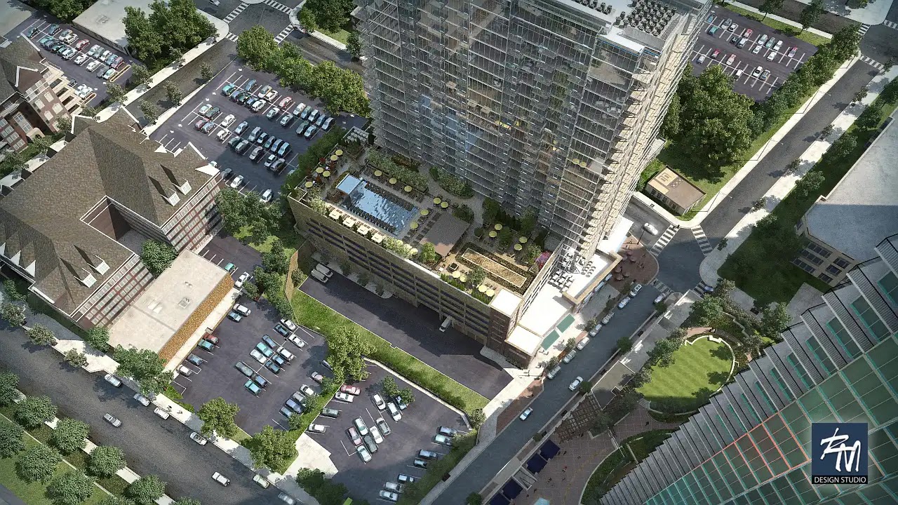 Aerial view of a modern multifamily building with rooftop pool and landscaping.