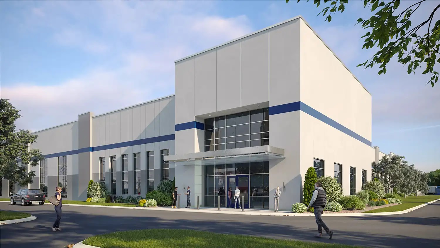 Exterior view of a modern commercial building with glass entrance and landscaped surroundings.