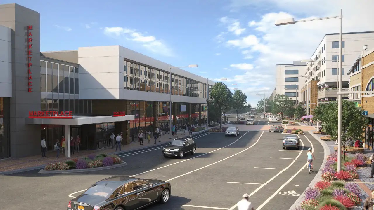 Street view of a modern mixed-use marketplace with storefronts and apartments.