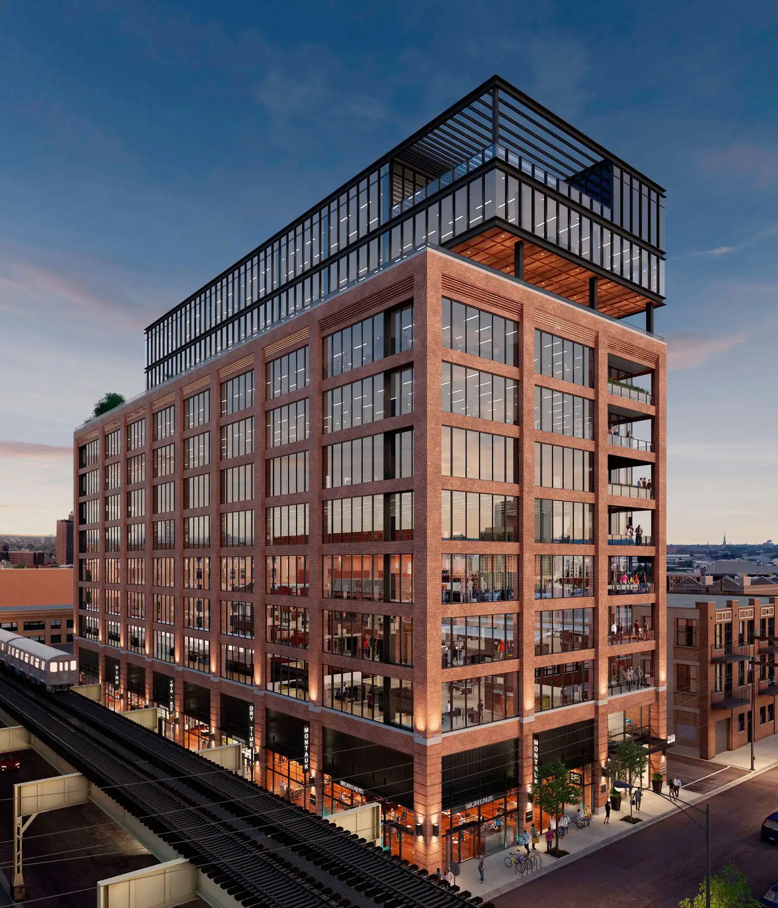 Modern mixed-use building with brick and glass facade at dusk.