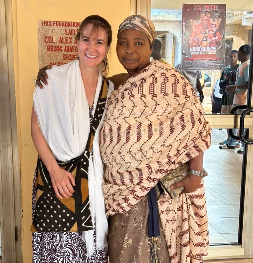 Two women posing for camera in traditional African outfits