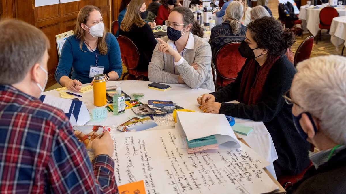 Vaccine equity community group sitting around table discussing