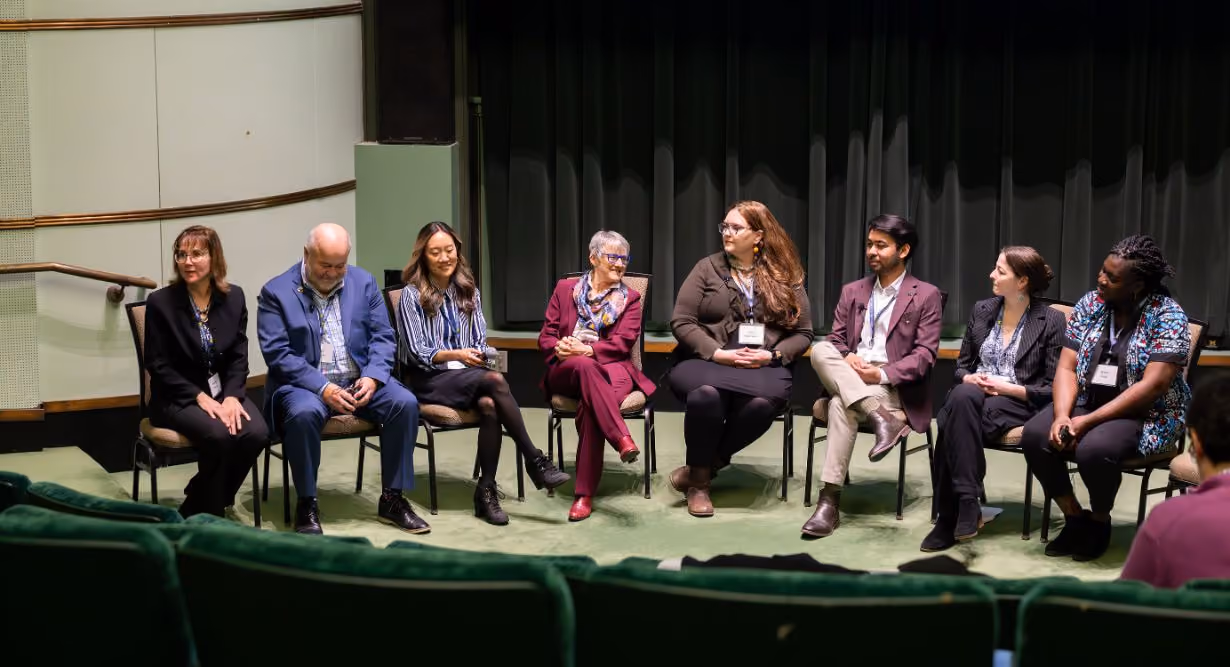 Eight members speaking on a panel at Center for Global Health Equity research symposium at University of Michigan