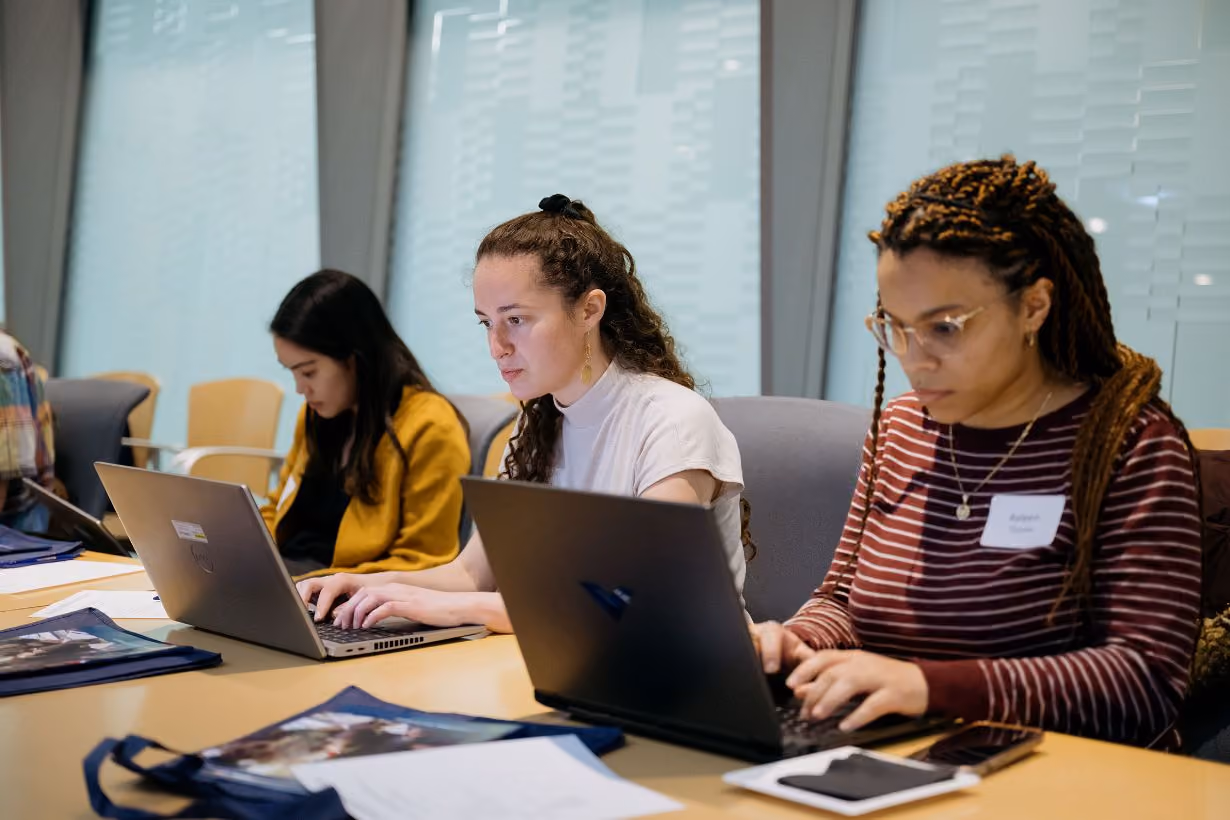 University of Michigan students work on laptops during Center for Global Health Equity summer internship