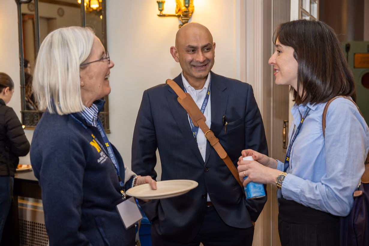 Three members chatting with each other at Center for Global Health Equity's annual community gathering event at the University of Michigan