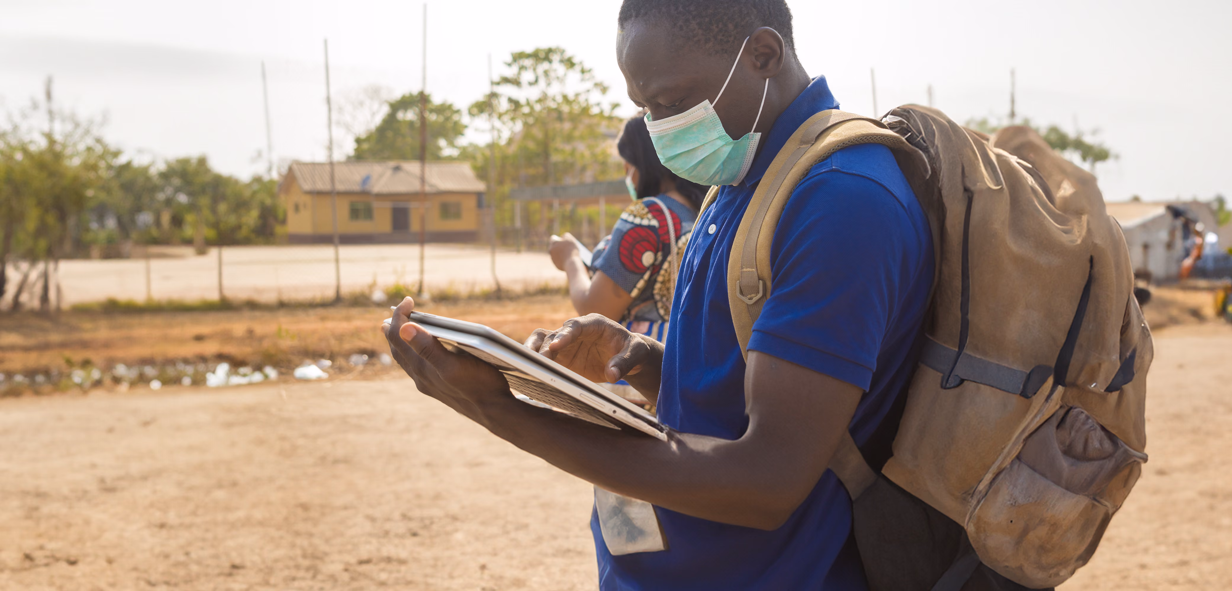 Field surveyor with laptop outside
