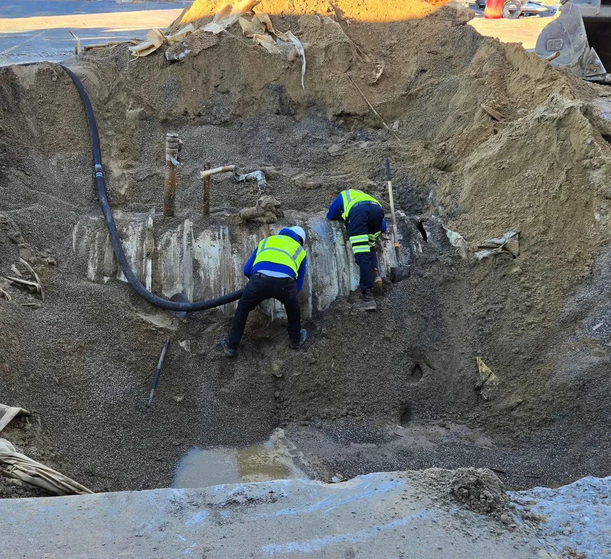 workers excavating an underground tank