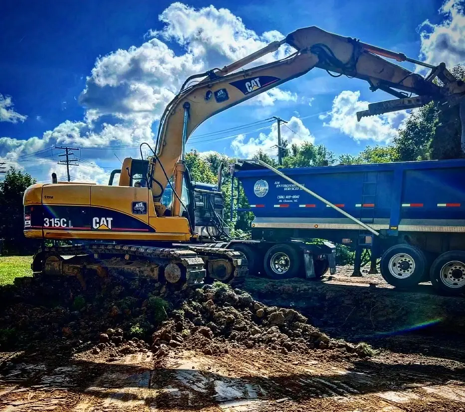 excavator next to dump truck