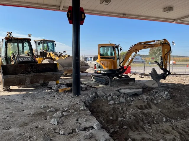 excavation equipment digging under structure
