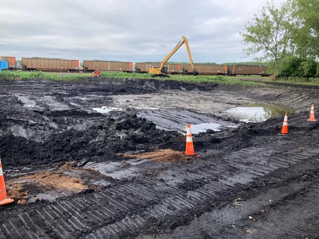 excavation site with train in background