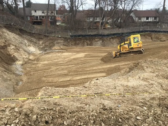 equipment vehicle pushing dirt in site