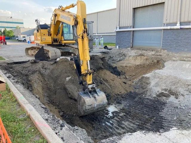 excavator digging soil on industrial site