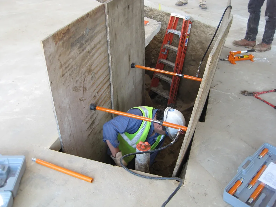 worker in cut out concrete section
