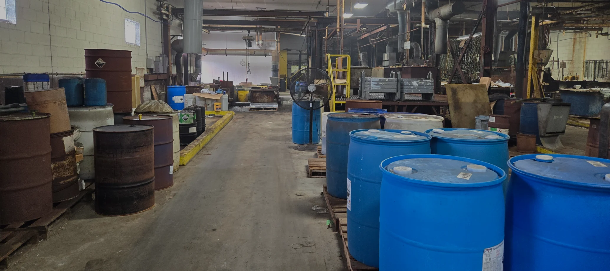 warehouse with pallets of drums overlay