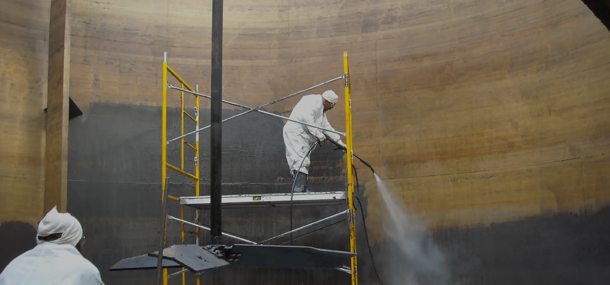 workers in tank cleaning insides overlay