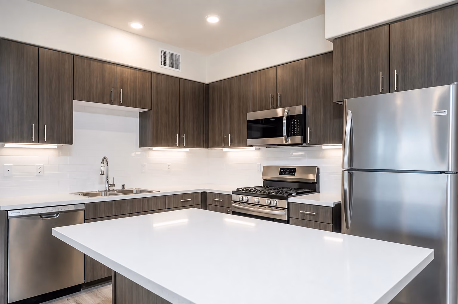 Kitchen with brown cabinets with stainless steel appliances