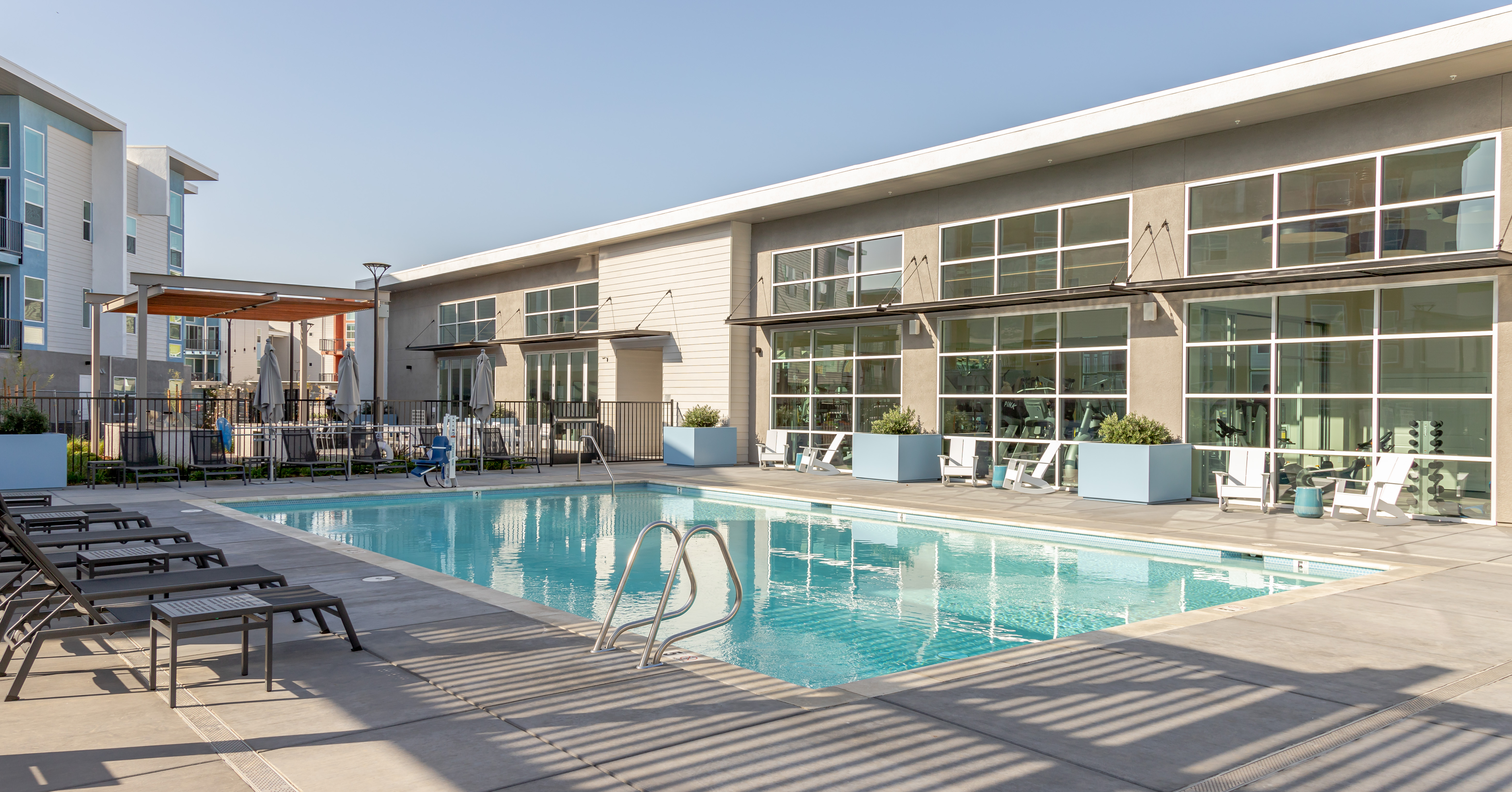Swimming pool with lounge chairs and view of exterior