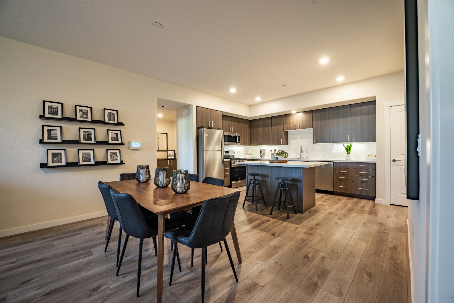 Kitchen island opening to a furnished dining area