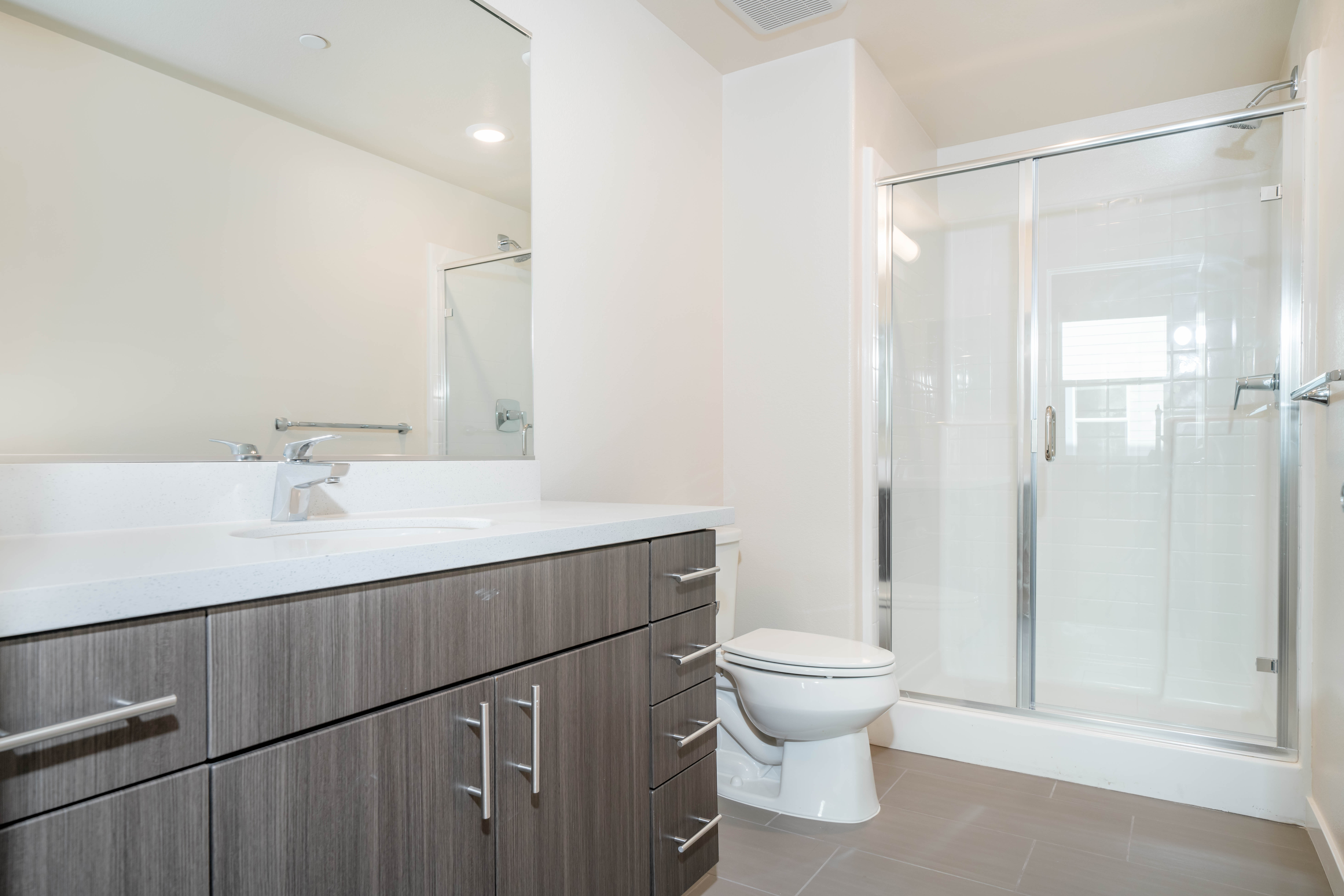 Bathroom with double-sink vanity and glass shower