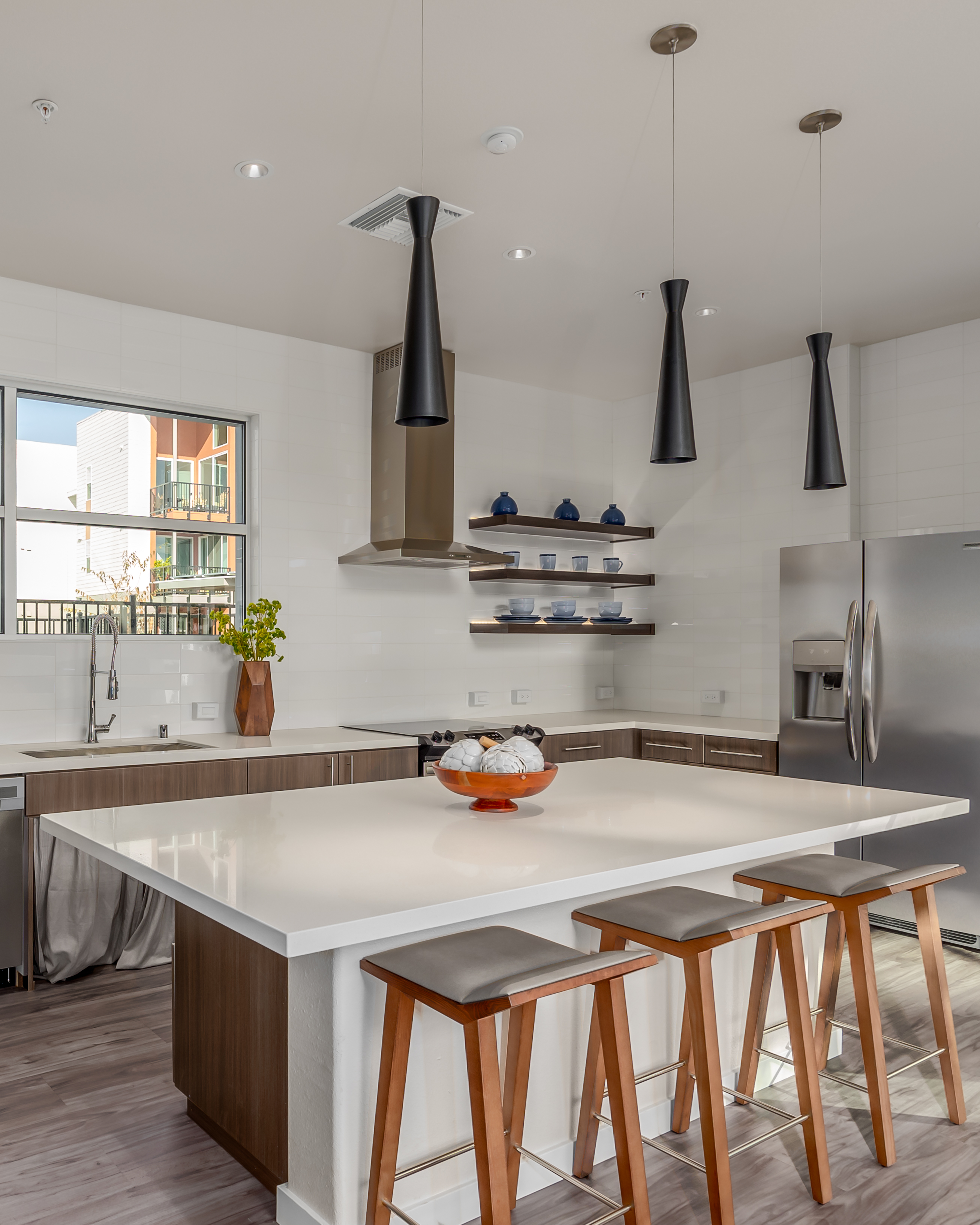 Community kitchen with island and shelves with dishes
