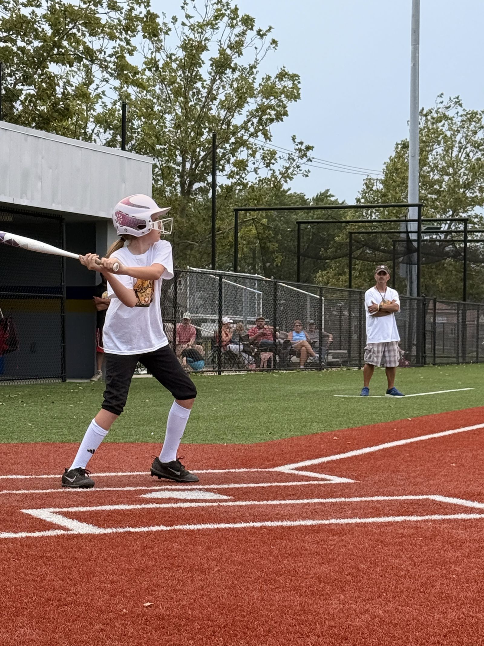 A batter follows through on a swing at the plate.