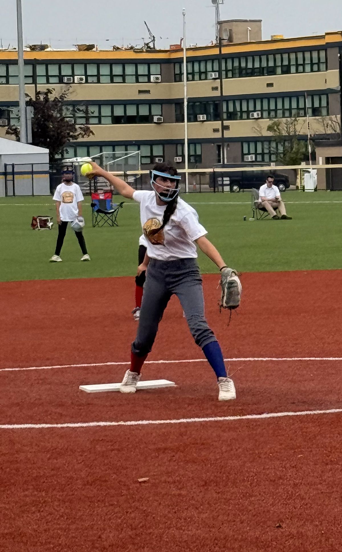 A pitcher releases the ball from the circle.
