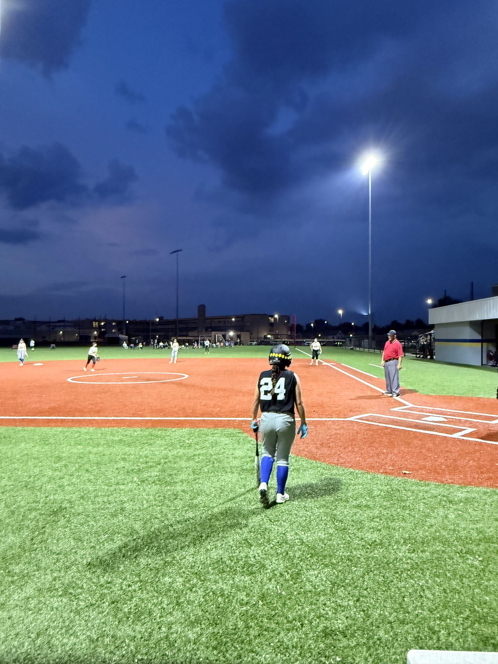 Number 24 walks out to the field at dusk.