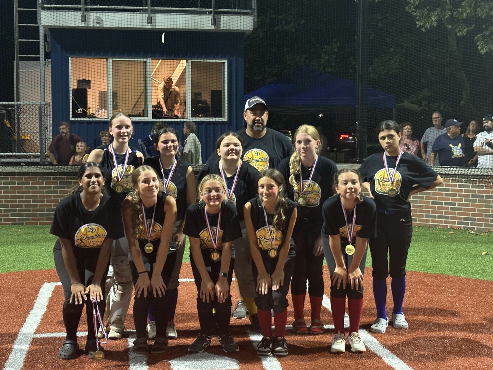 A team poses together with their medals.