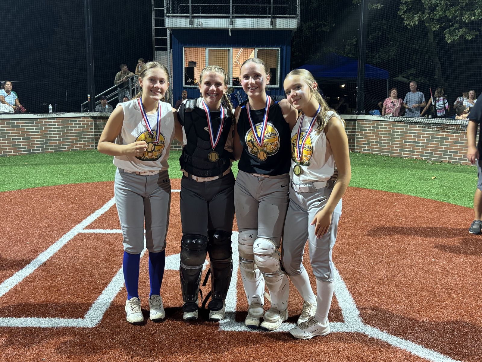 Four teammates celebrate with their medals.