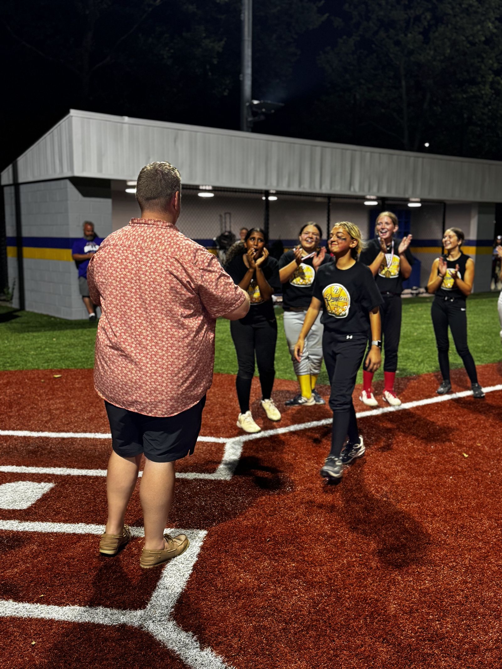 A player receives her medal from a coach.