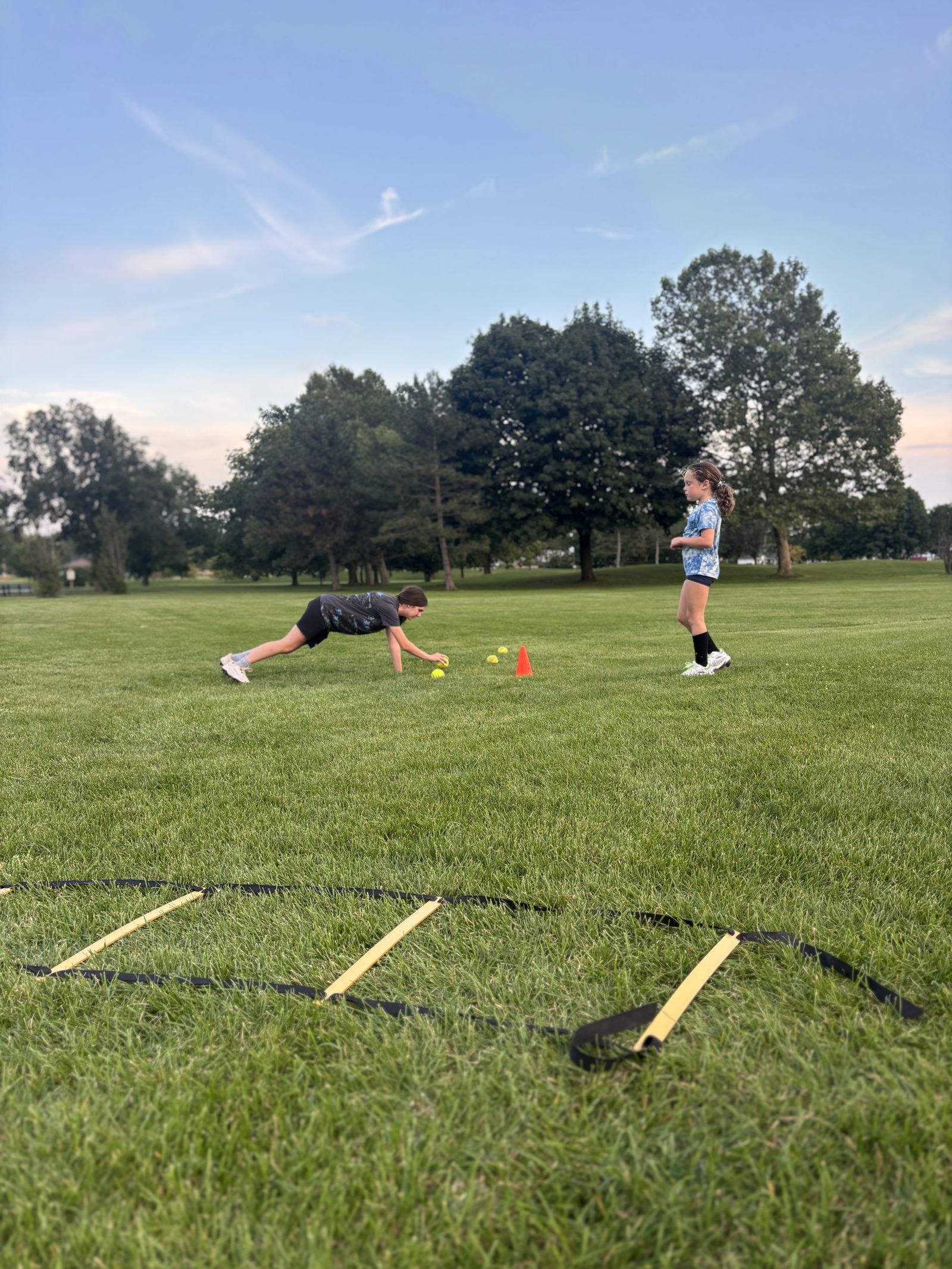 Players run the agility ladder at a clinic.
