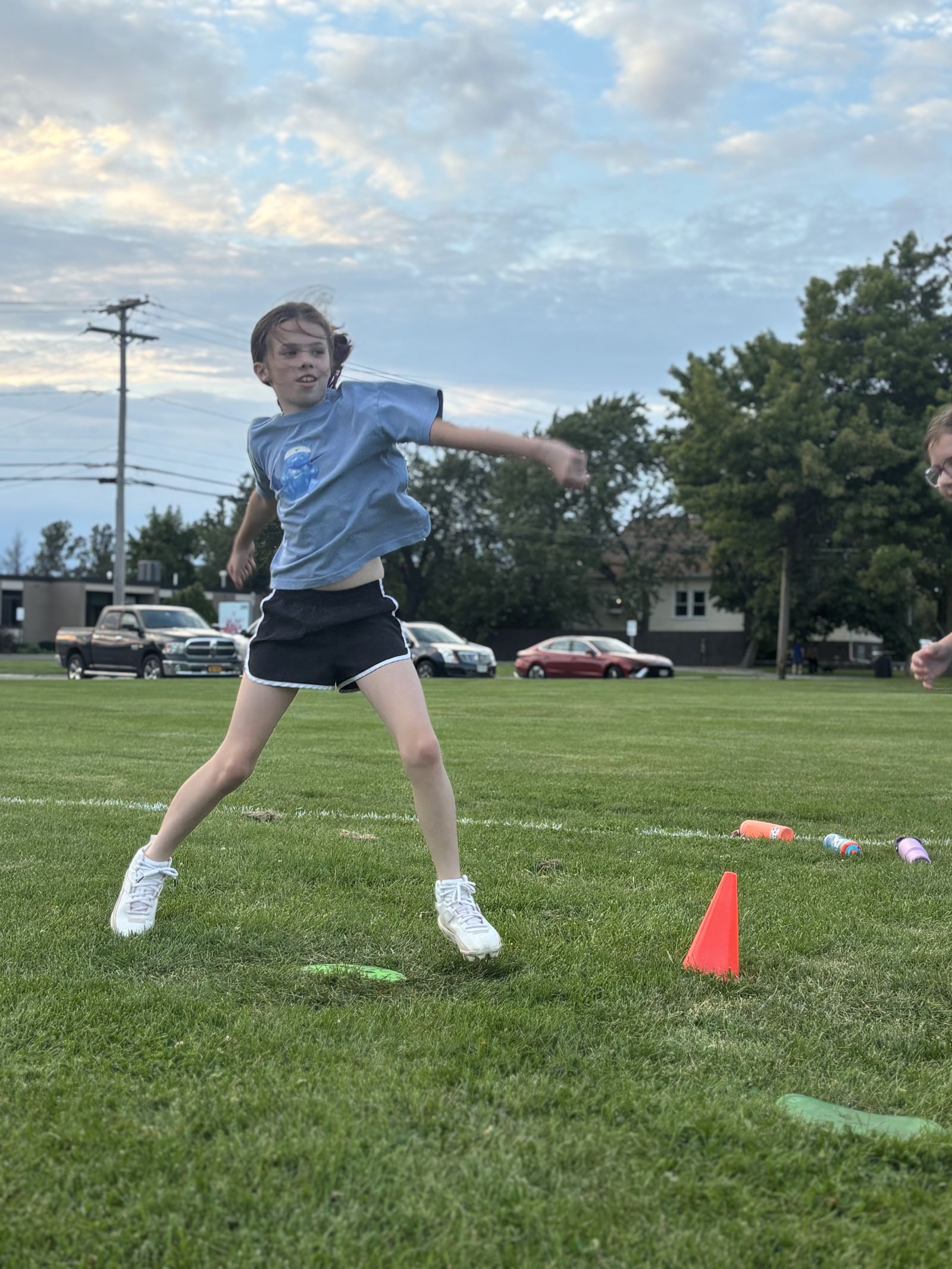 A player throws during a clinic drill.