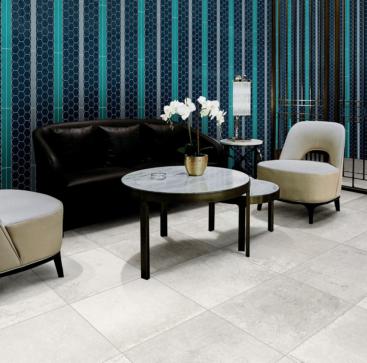 Modern lounge with black sofa, beige chairs, round marble tables, white orchid, and blue patterned wall.