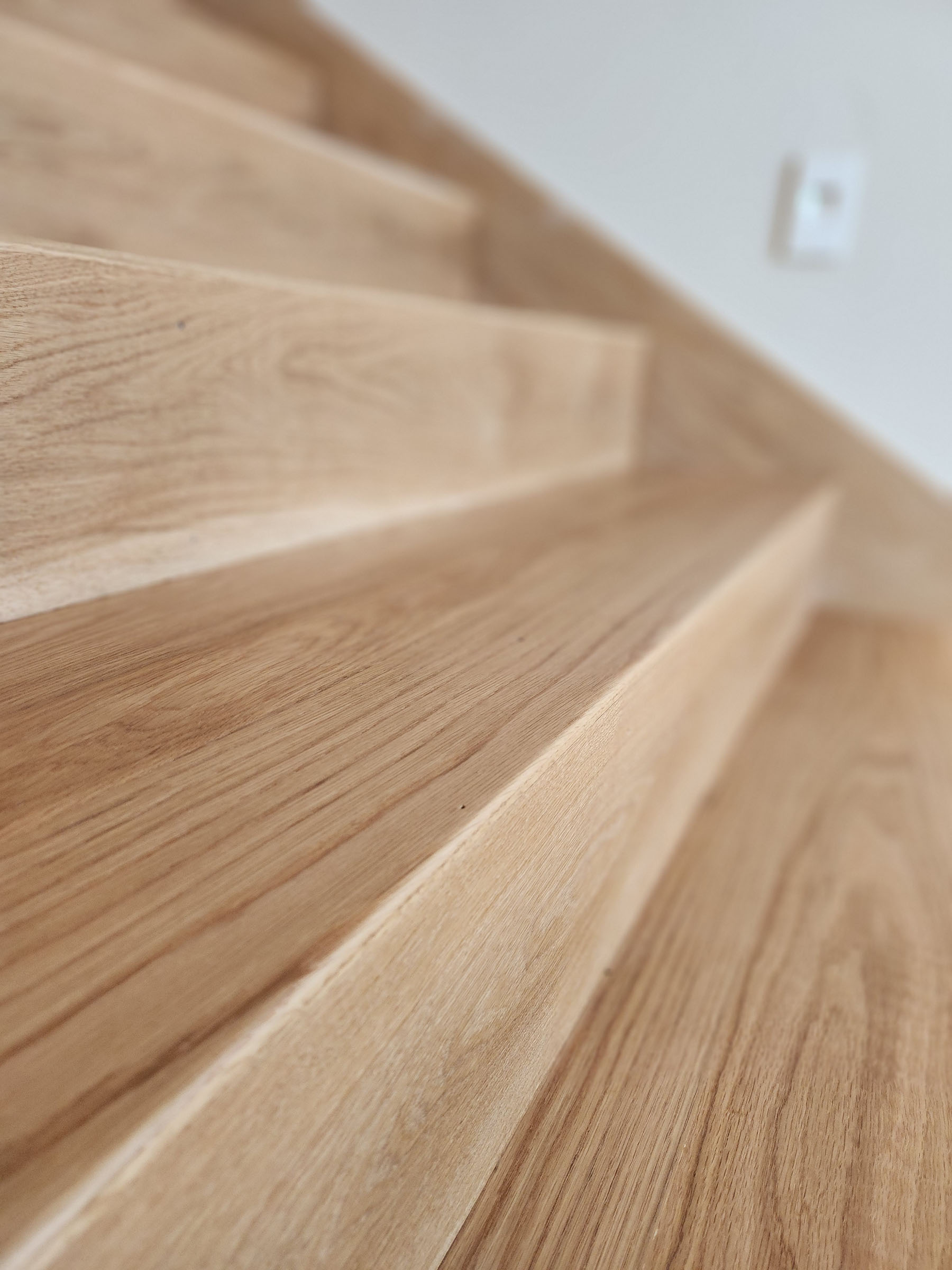 Close-up of light wood stairs focusing on wood grain and texture.
