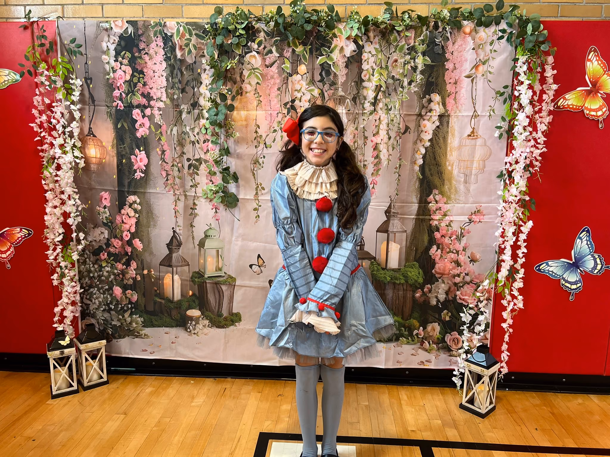 Student in costume posing at school theatrical performance backdrop