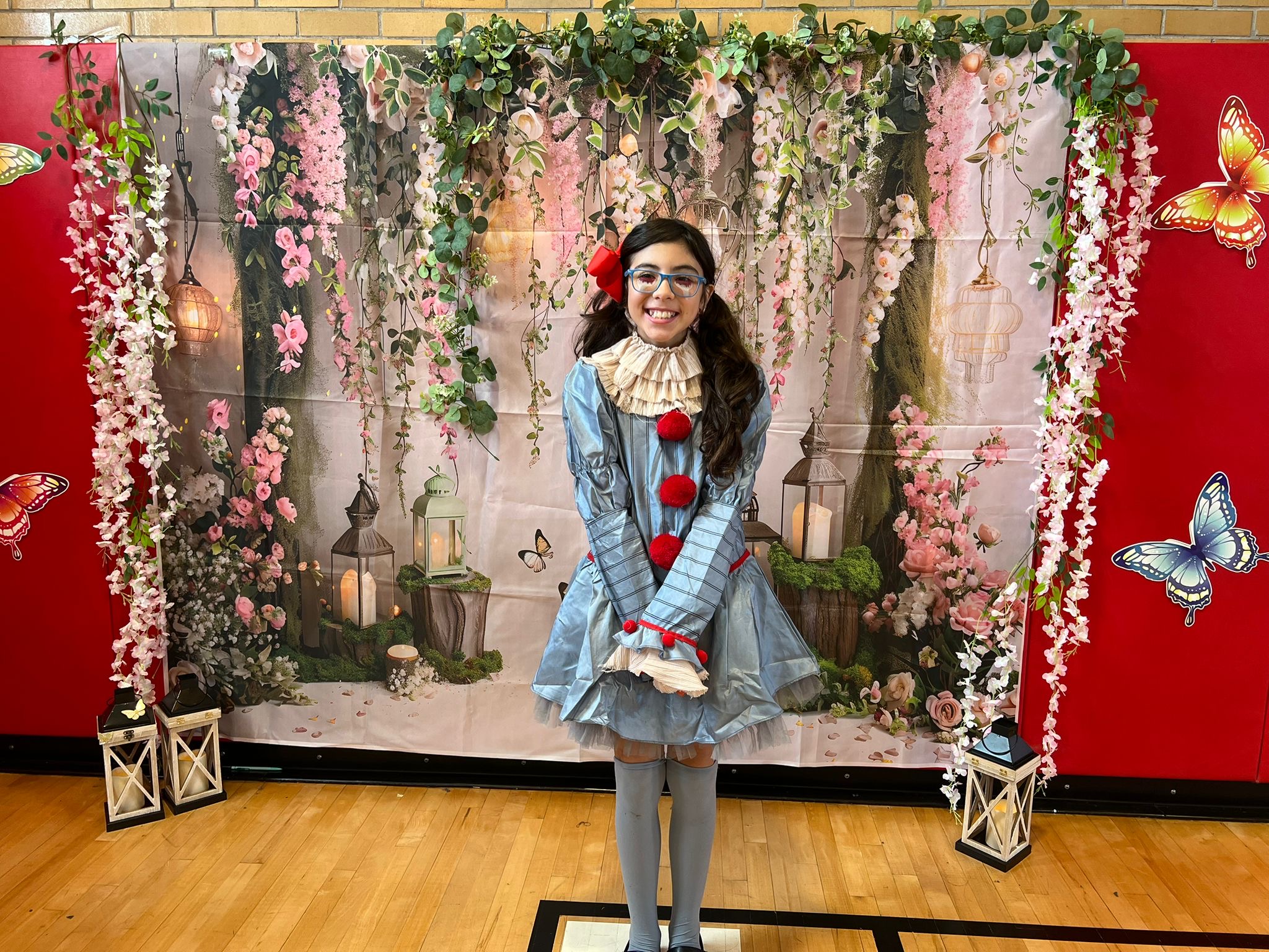 Student in costume posing at school theatrical performance backdrop