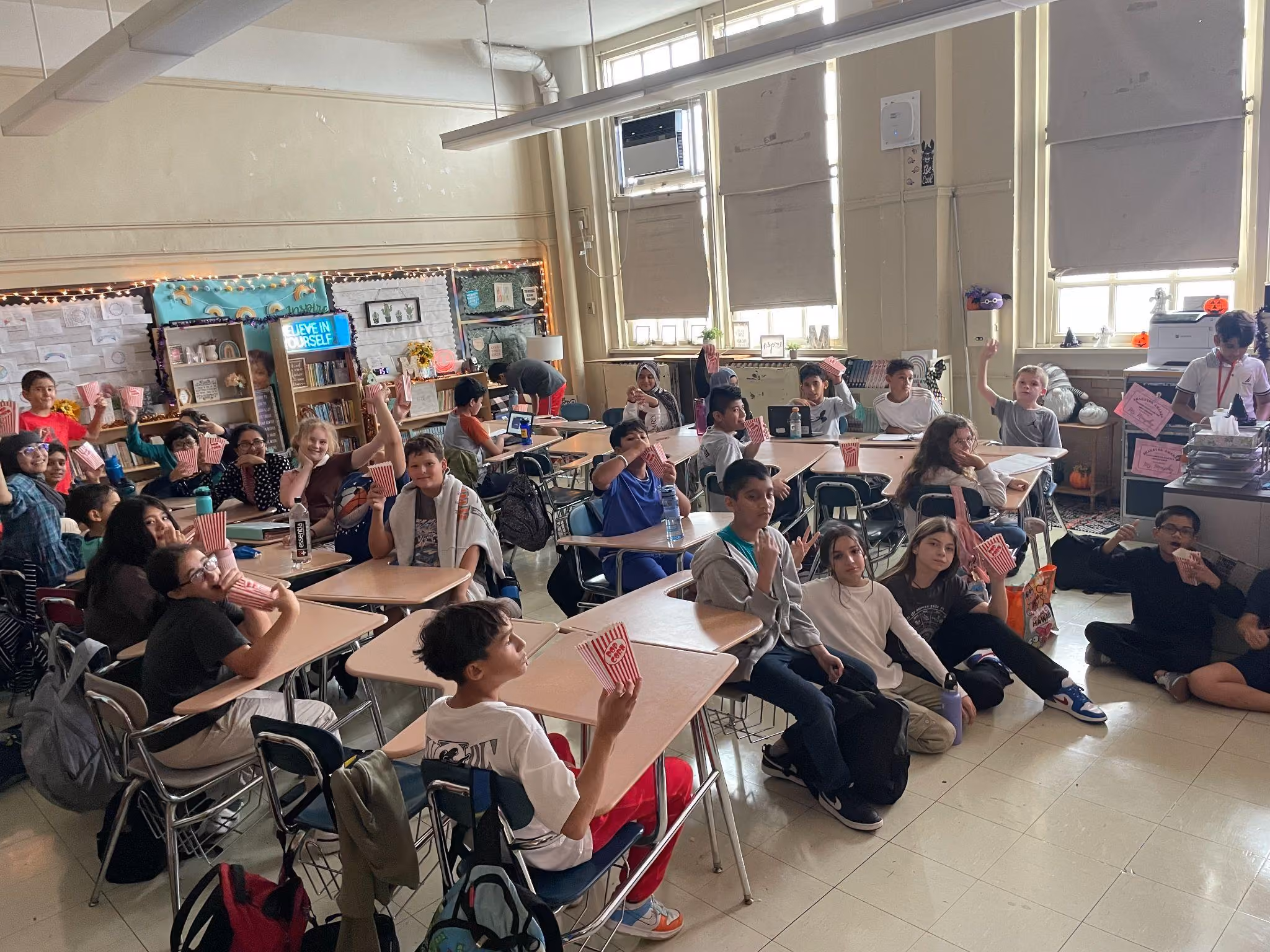 Students enjoying popcorn during a classroom movie or activity