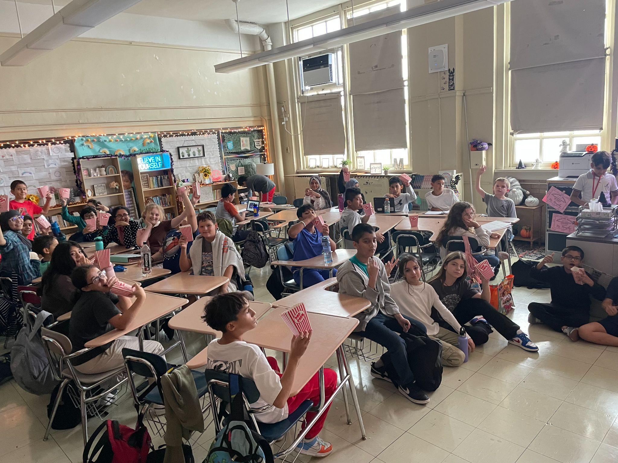 Students enjoying popcorn during a classroom movie or activity
