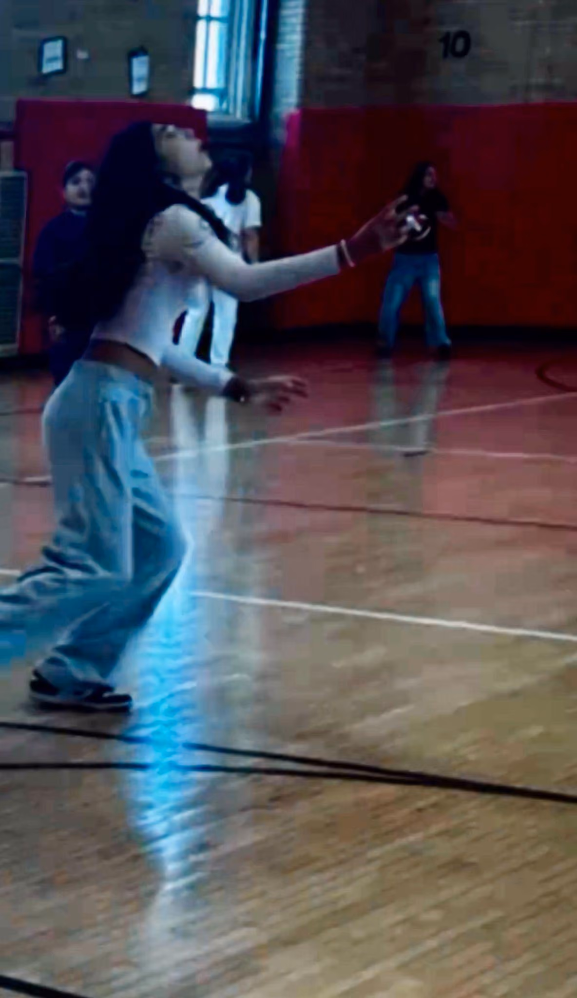 Student looking up while playing in school gymnasium