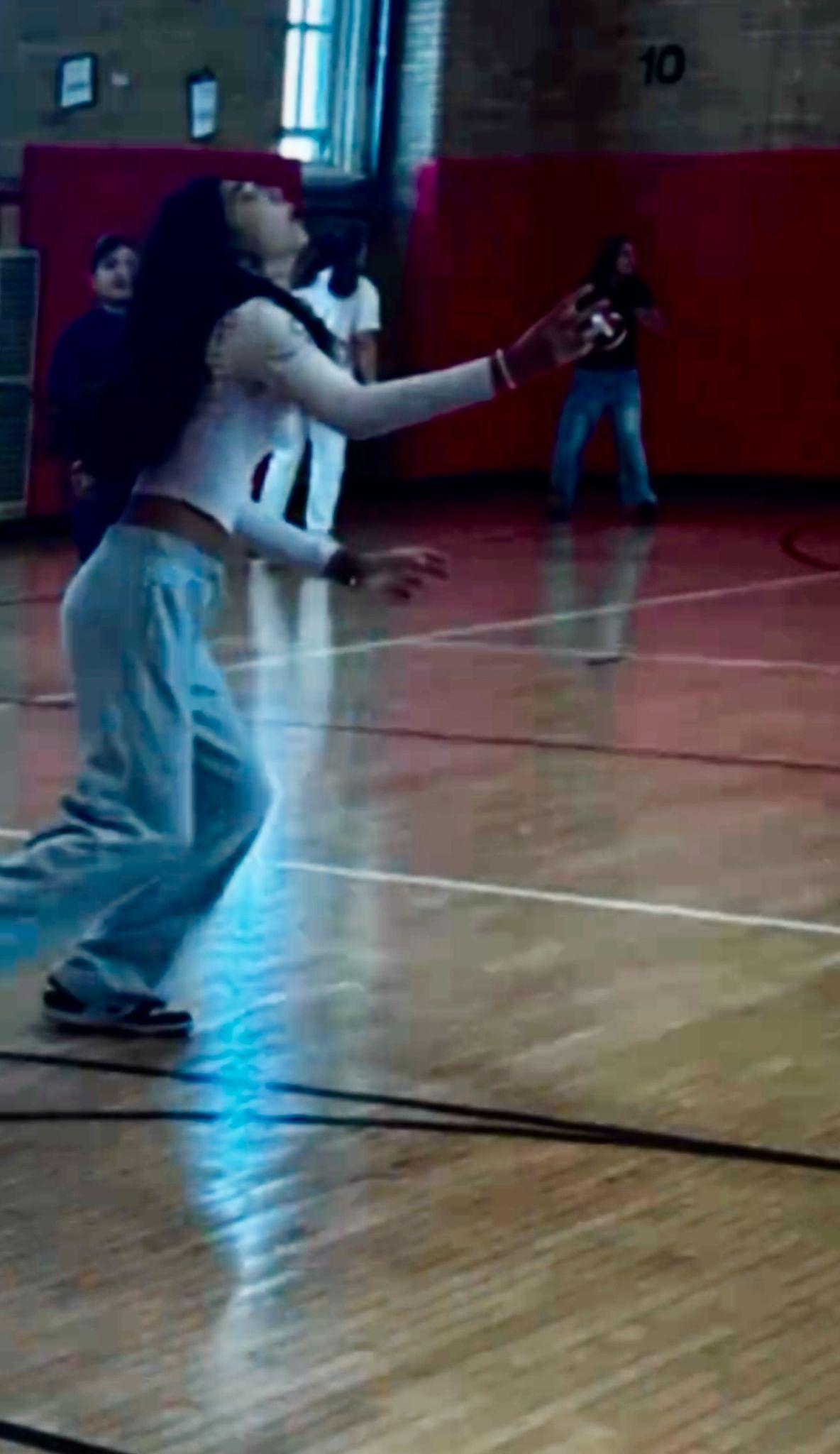 Student looking up while playing in school gymnasium