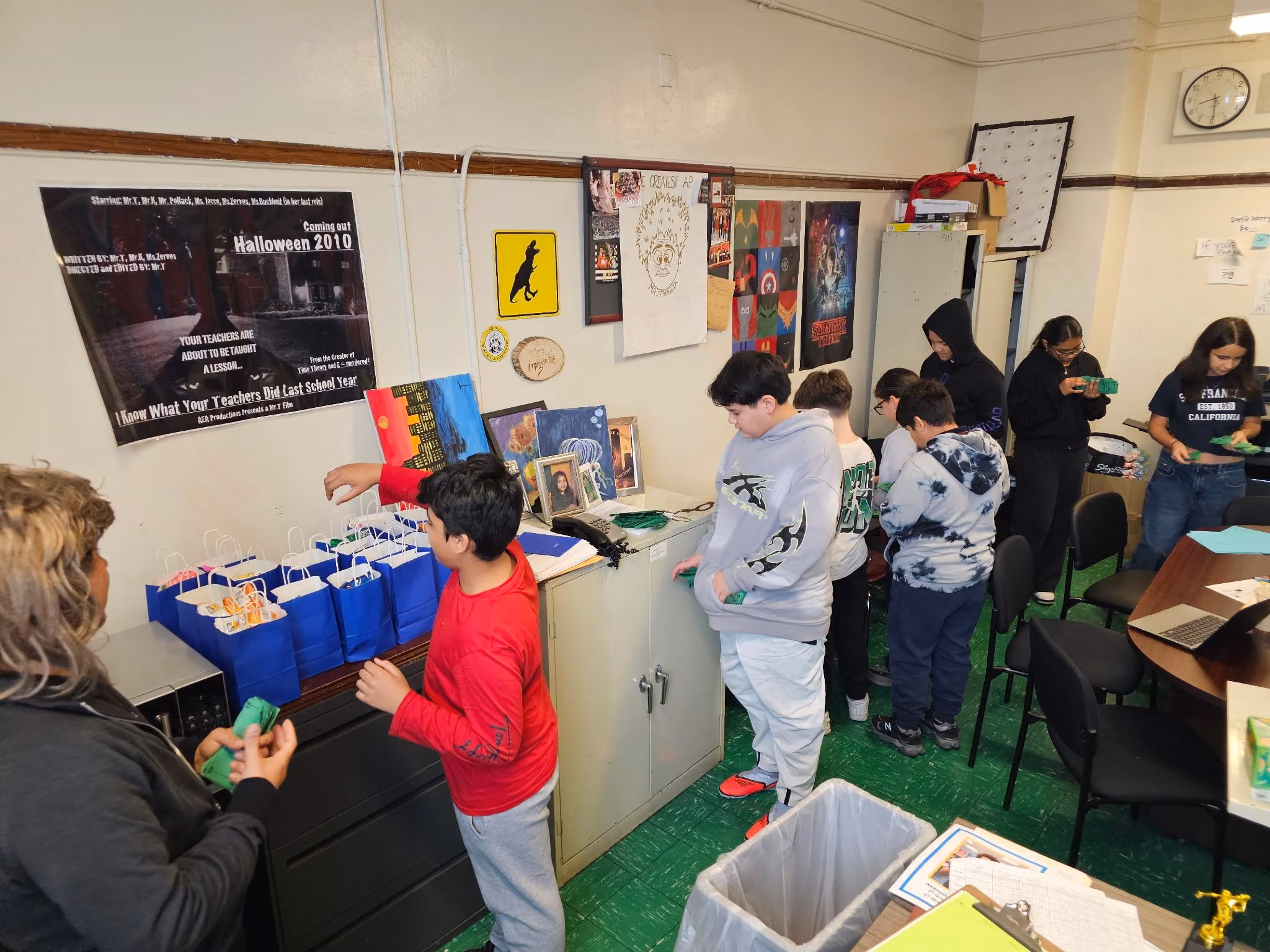 Students and teacher assembling gift bags in a decorated classroom
