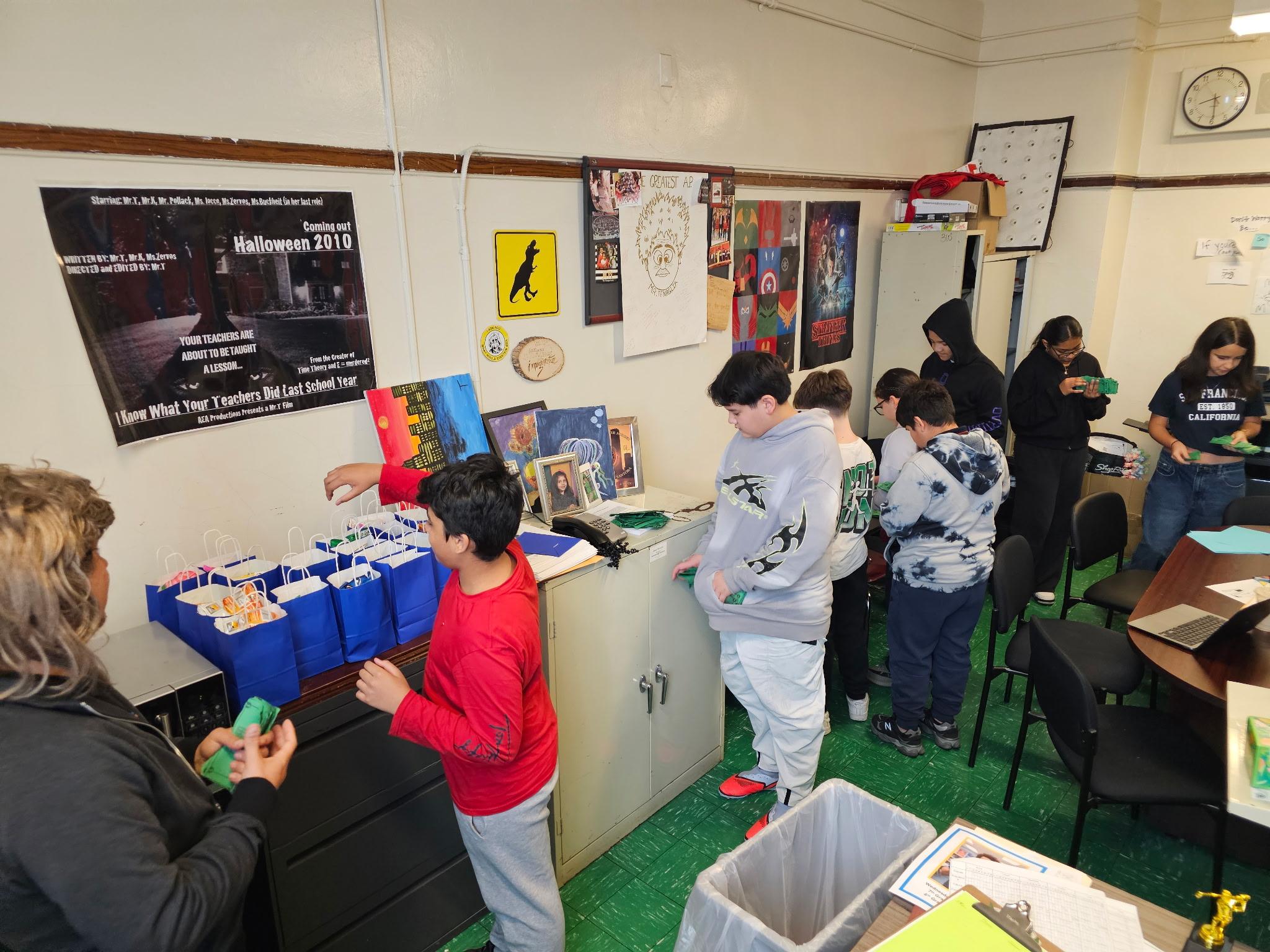 Students and teacher assembling gift bags in a decorated classroom