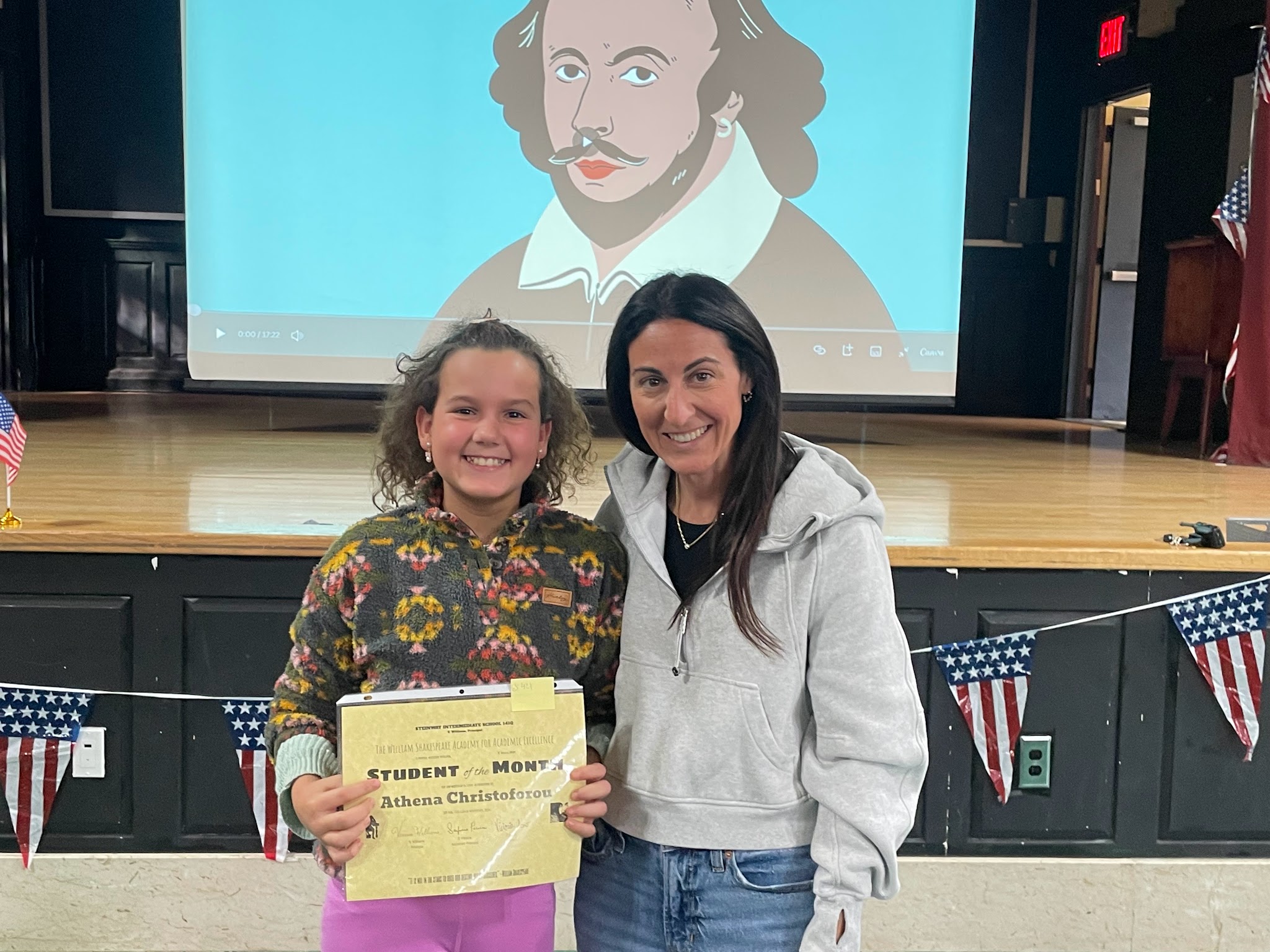 Athena Christoforou receives Student of the Month certificate with adult