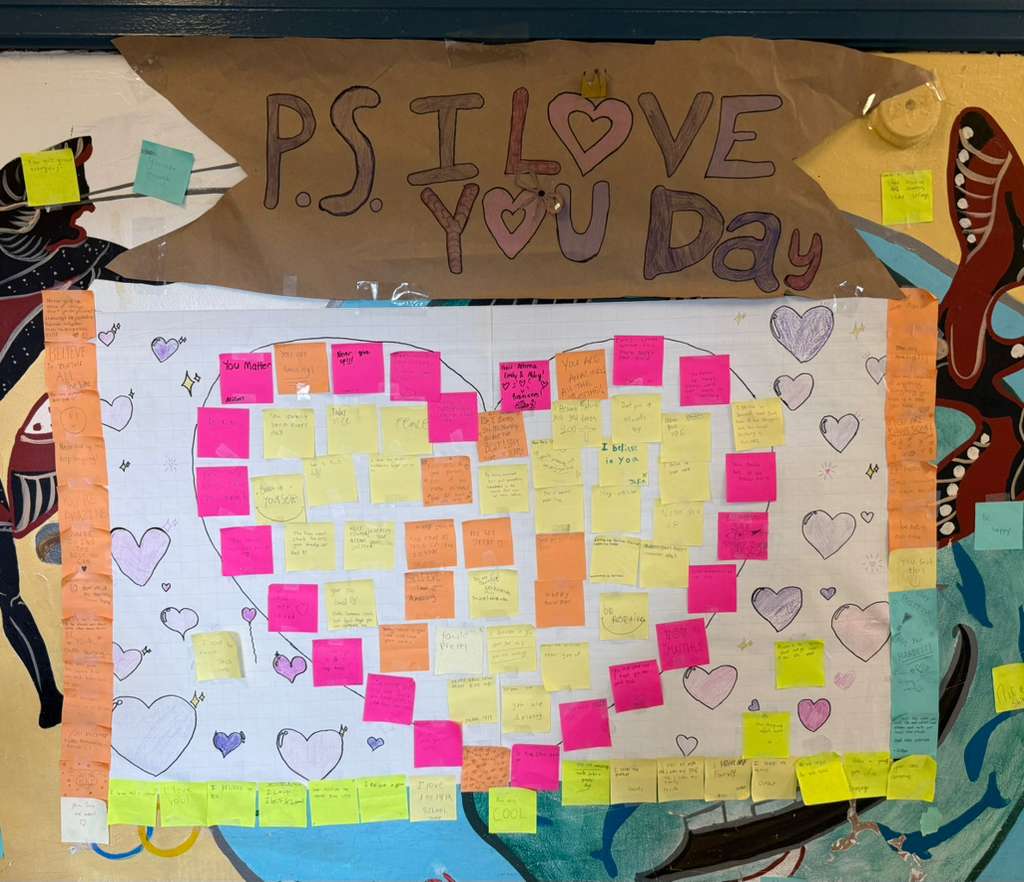 Student-made PS I Love You Day bulletin board with colorful sticky notes