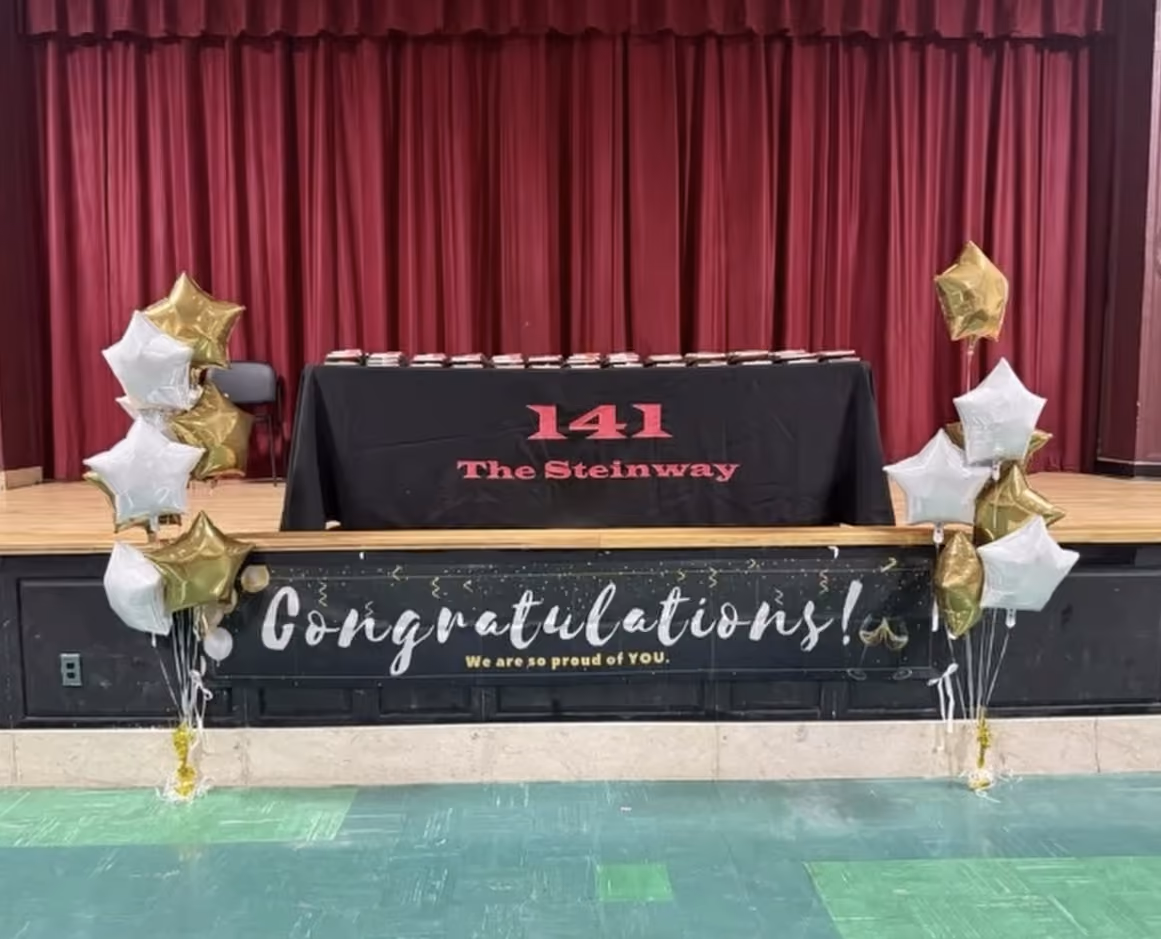 PS 141 Steinway graduation stage decorated with balloons and congratulations banner
