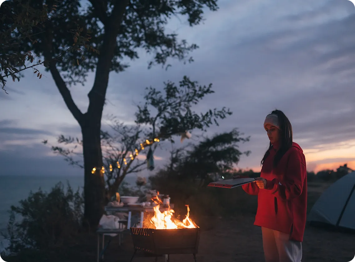 Campfire by lake at dusk