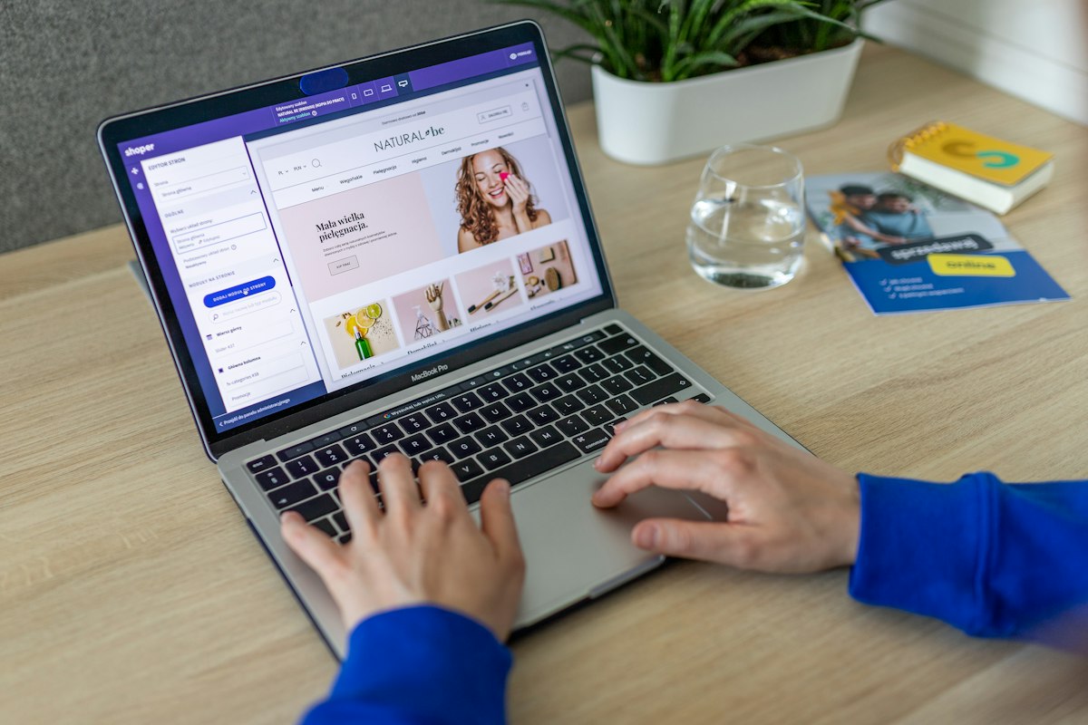 Person working on a laptop reviewing an online store layout