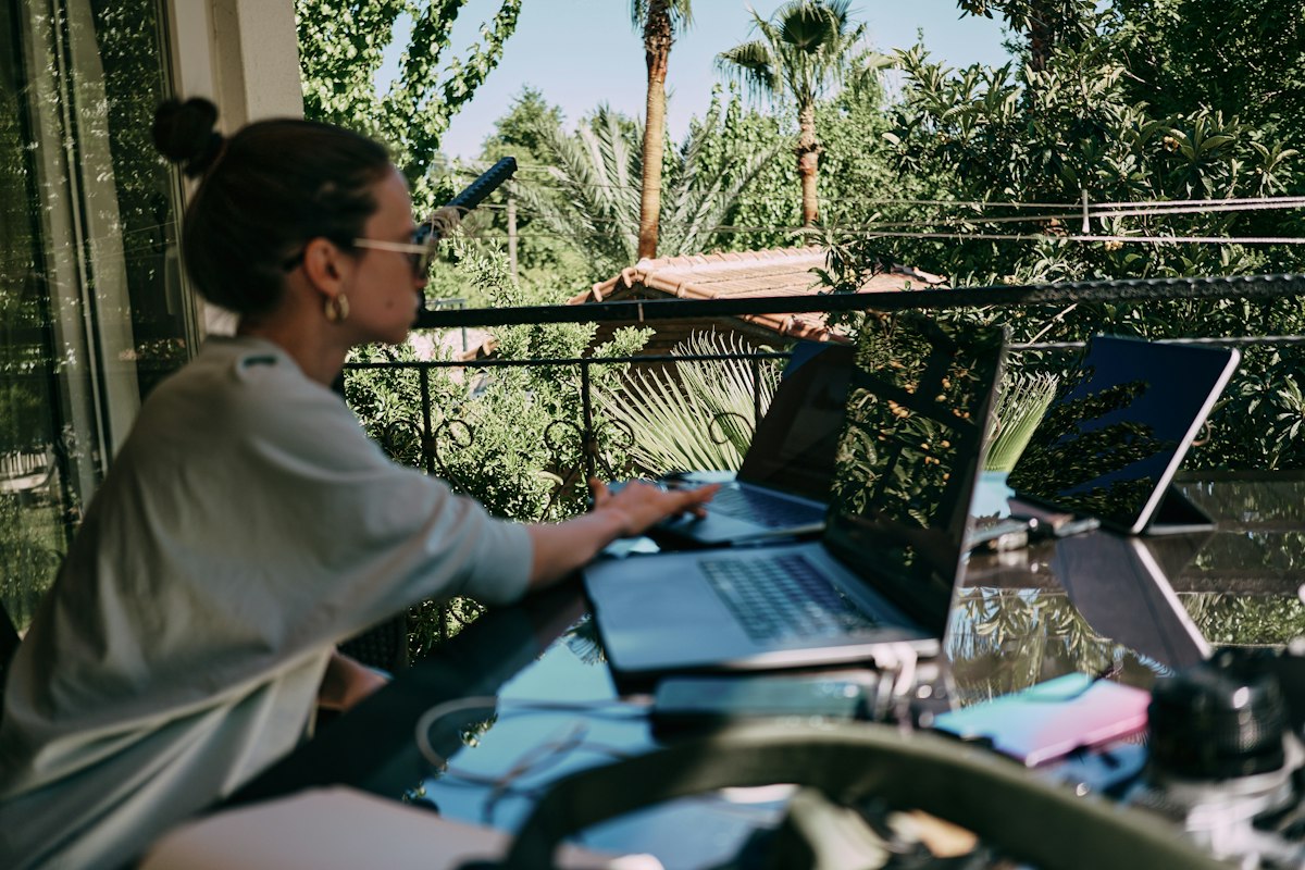 Freelancer working on a laptop at an outdoor table
